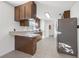 Galley kitchen with wood cabinets and tile floors at 905 Lake Fuller Dr, Lutz, FL 33548