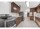 Spacious kitchen, featuring stainless steel appliances and wood cabinets at 905 Lake Fuller Dr, Lutz, FL 33548