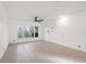 Spacious living room with tile floors and large windows at 905 Lake Fuller Dr, Lutz, FL 33548