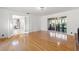 Open living room with hardwood floors, white walls, and sliding doors that lead to the outside at 905 Lake Fuller Dr, Lutz, FL 33548