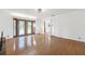Sunlit living room featuring hardwood floors, white walls, and a view into the front yard at 905 Lake Fuller Dr, Lutz, FL 33548