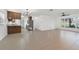 Large open living room with tile floors, a view of the lake, and neutral colored walls at 905 Lake Fuller Dr, Lutz, FL 33548