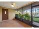 Screened porch with tile floor and tranquil lake view at 905 Lake Fuller Dr, Lutz, FL 33548