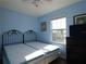 Guest bedroom with two twin-size beds and window at 9107 Brunswick Ln, Tampa, FL 33615