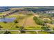 Aerial view of expansive property with road frontage and surrounding pastureland at 9229 Fort King Rd Rd, Dade City, FL 33525