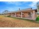 Brick ranch home features a long covered porch overlooking the yard at 9229 Fort King Rd Rd, Dade City, FL 33525