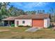 Detached garage with roll-up door and screened lean-to at 9229 Fort King Rd Rd, Dade City, FL 33525