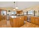 Kitchen features island, stainless steel appliances, and wood cabinets at 9229 Fort King Rd Rd, Dade City, FL 33525