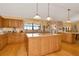 Large kitchen with island, wood cabinets, and granite countertops at 9229 Fort King Rd Rd, Dade City, FL 33525