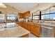 Bright kitchen with wood cabinets, granite counters & stainless steel appliances at 9229 Fort King Rd Rd, Dade City, FL 33525