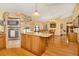 Spacious kitchen with island, wood cabinets, and granite countertops at 9229 Fort King Rd Rd, Dade City, FL 33525