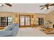 Spacious living room featuring hardwood floors, comfortable sofas, and large windows at 9229 Fort King Rd Rd, Dade City, FL 33525
