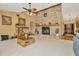Living room with brick fireplace, ceiling fan, and large windows at 9229 Fort King Rd Rd, Dade City, FL 33525