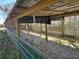 Inside a pole barn with gravel floor, green metal siding, and a wood-framed roof at 9229 Fort King Rd Rd, Dade City, FL 33525