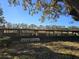 The side of a long metal pole barn with a green John Deere Gator in the distance at 9229 Fort King Rd Rd, Dade City, FL 33525
