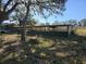A large metal pole barn surrounded by trees and grass at 9229 Fort King Rd Rd, Dade City, FL 33525