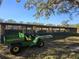 Large metal pole barn shed with a green John Deere Gator parked in front at 9229 Fort King Rd Rd, Dade City, FL 33525