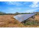 Ground-mounted solar panel array in a rural setting at 9229 Fort King Rd Rd, Dade City, FL 33525