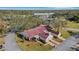 An aerial view of a home with a tile roof, two-car garage, and landscaping at 947 Madrid Dr, Palm Harbor, FL 34684