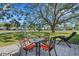 Inviting patio area with seating under a large tree at 947 Madrid Dr, Palm Harbor, FL 34684