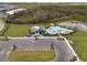 Aerial view of community pool, clubhouse, and parking lot at 10303 Charlotte Dr, Parrish, FL 34219