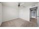Simple bedroom with carpet, ceiling fan, and door to hallway at 10303 Charlotte Dr, Parrish, FL 34219