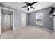 Light grey bedroom with carpet, ceiling fan and window at 10303 Charlotte Dr, Parrish, FL 34219