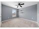 Simple bedroom with grey walls, ceiling fan, and window at 10303 Charlotte Dr, Parrish, FL 34219