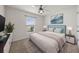 Bright bedroom with a queen bed, window, and ceiling fan at 10303 Charlotte Dr, Parrish, FL 34219