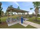 Community park with picnic tables, playground, and water fountain at 10303 Charlotte Dr, Parrish, FL 34219