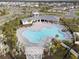 Relaxing community pool with plenty of lounge chairs and a unique design at 10303 Charlotte Dr, Parrish, FL 34219