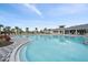Inviting community pool with plenty of lounge chairs and a view of the surrounding area at 10303 Charlotte Dr, Parrish, FL 34219