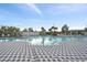 Large community pool with a spacious deck area and comfortable lounge chairs at 10303 Charlotte Dr, Parrish, FL 34219