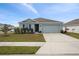 Single-story home with attached garage and landscaped front yard at 10303 Charlotte Dr, Parrish, FL 34219