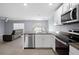 Open-concept kitchen with stainless steel appliances and island at 10303 Charlotte Dr, Parrish, FL 34219