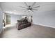 Open living room with tile floor, ceiling fan and view of kitchen at 10303 Charlotte Dr, Parrish, FL 34219