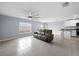 Spacious living room with tile floors and a view into the kitchen at 10303 Charlotte Dr, Parrish, FL 34219