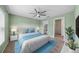 Main bedroom with green accent wall and ensuite bathroom at 10303 Charlotte Dr, Parrish, FL 34219