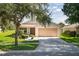 One-story house with a two-car garage and well-maintained lawn at 11317 Coconut Island Dr, Riverview, FL 33569