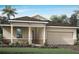 One-story house with light beige siding, stone accents, and a two-car garage at 12348 49Th E St, Parrish, FL 34219