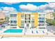 Drone view of a beachside condo building with pool and parking at 16308 Gulf Blvd # 303, Redington Beach, FL 33708