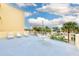 Relaxing patio area with lounge chairs and small table at 16308 Gulf Blvd # 303, Redington Beach, FL 33708