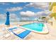 Inviting pool area with lounge chairs and beach umbrellas at 16308 Gulf Blvd # 303, Redington Beach, FL 33708