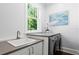 Modern laundry room with a sink and front-load washer/dryer at 2003 W Dekle Ave, Tampa, FL 33606