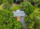 Aerial view of a house with a large yard and a dock at 20735 Gardenia Dr, Land O Lakes, FL 34638