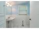 Simple bathroom with pedestal sink and light blue walls at 20735 Gardenia Dr, Land O Lakes, FL 34638