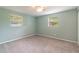 Bedroom with light-green walls, carpet, and two windows at 20735 Gardenia Dr, Land O Lakes, FL 34638