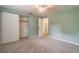 Light-green bedroom with carpet, ceiling fan, and double-door closet at 20735 Gardenia Dr, Land O Lakes, FL 34638