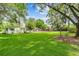 Ranch home with a large front yard and mature trees at 20735 Gardenia Dr, Land O Lakes, FL 34638