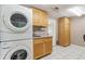 Laundry room with washer, dryer, cabinets, and utility sink at 20735 Gardenia Dr, Land O Lakes, FL 34638